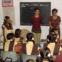 Students interacting with school girls at a village school